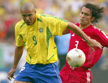 Brazil's Ronaldo (L) battles Turkey's Bulent Korkmaz during their World Cup Finals match in Ulsan, South Korea, June 3, 2002.