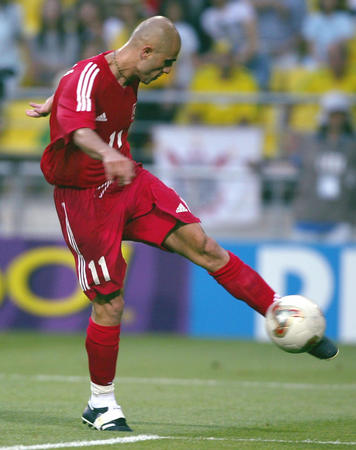 Turkey's Hasan Sas kicks the ball to score against Brazil in the first half of their World Cup Finals match in Ulsan, South Korea, June 3, 2002. 