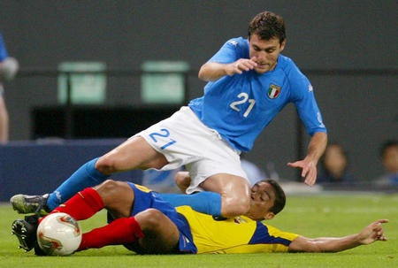 Italy's goal scorer Christian Vieri falls over Ecuador's Edwin Tenorio during their group G match at the World Cup Finals in Sapporo June 3, 2002.