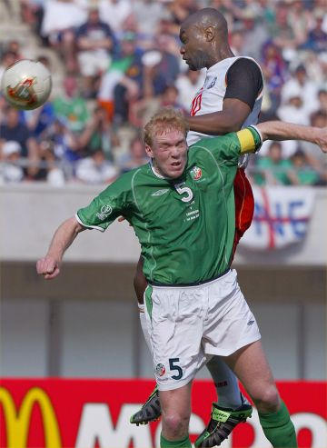 Cameroon striker Patrick Mboma (R) heads off the ball despite Irish captain Steve Staunton (L) during the Ireland/Cameroon Group E match of the first round of the 2002 FIFA World Cup Korea Japan 01 June 2002 at Niigata Big Swan stadium. 