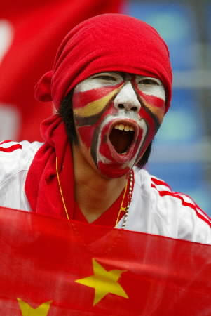 A fan of Chinese soccer cheers before the Group C match between China and Costa Rica at the World Cup finals in Kwangju, South Korea, June 4, 2002. This is the first time China has played in a World Cup. 