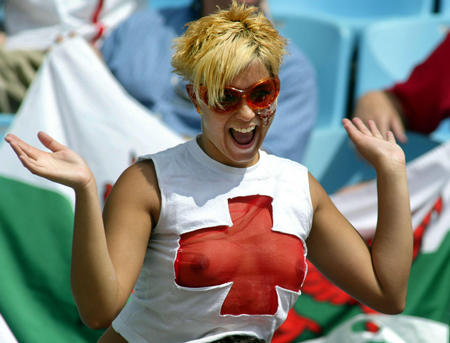 An England supporter wearing a transparent shirt cheers before the start of a group F World Cup Finals match between England and Nigeria at the Nagai stadium in Osaka June 12, 2002