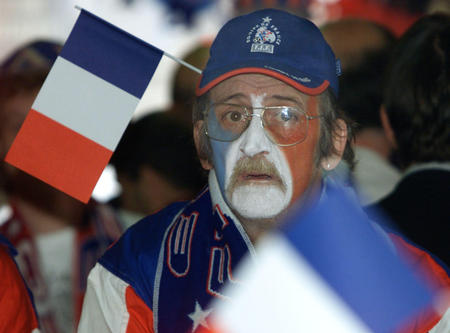 A French soccer fan with his face painted reacts in a pub in Lille June 11, 2002 after France were knocked out of the World Cup in the southern Korean city of Inchon after a 2-0 defeat by Denmark