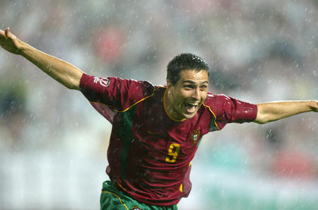 Portugal's Pauleta runs in the rain to celebrate after he scored his second goal against Poland in their World Cup Finals match in Chonju, June 10, 2002
