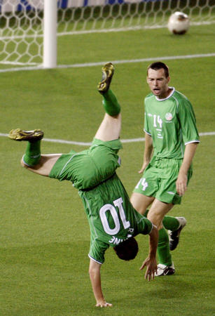 Ireland's Robbie Keane somersaults in celebration after scoring in front of team mate Gary Breen during their group E match against Saudi Arabia at the World Cup Finals in Yokohama June 11, 2002