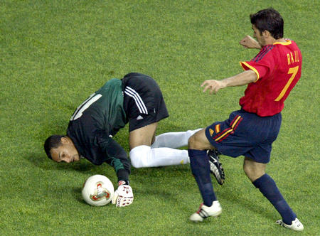 Spain's Raul advances on the ball to score a goal against South Africa's Andre Arendse (L) during their World Cup Finals match in Taejon, June 12, 2002