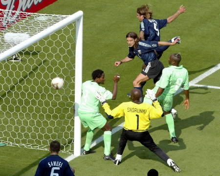 Argentina's Gabriel Batistuta (top) heads in from the tightest of angles amidst a posse of Nigerian defenders during their Group F match at the World Cup Finals in Ibaraki June 2, 2002.