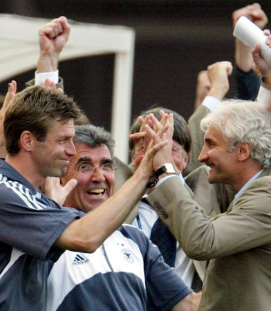 Germany's coach Rudi Voeller (R) celebrates their win over Paraguay with assistant coach Michael Skibbe (L) and team doctor Josef Schmitt after their second round match at the World Cup finals in Sogwipo June 15, 2002. Germany won the match 1-0.