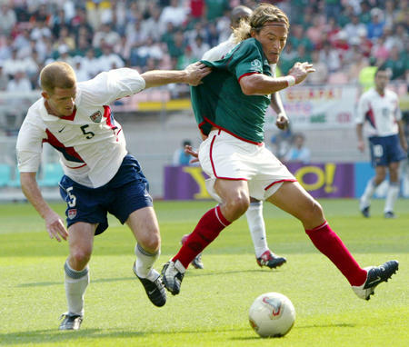 U.S. player John O'Brien (L) grabs Mexico's Luis Hernandez by the shirt during the second half of a second round World Cup Finals match in Chonju, June 17, 2002