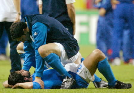 Italy's Marco Materazzi (top) consoles team mate Gennaro Gattuso after their World Cup second round defeat by South Korea
