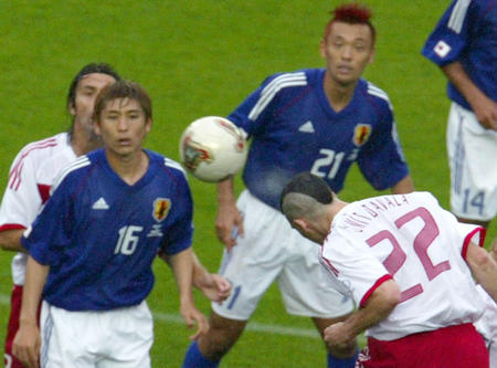Japan's Koji Nakata (L) and Kazuyuki Toda (R) watch as Umit Davala of Turkey scores the goal during the second round World Cup Finals match in Sendai June 18, 2002.