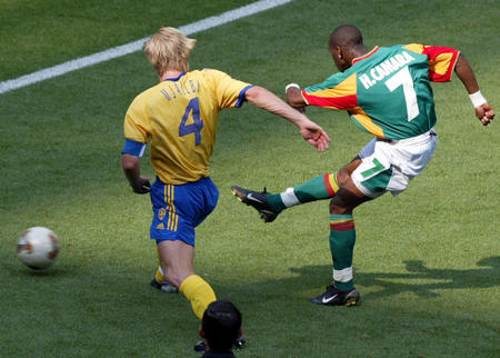 Senegal's Henri Camara (R) scores an equalizer as Sweden's Johan Mjallby tries to stop him during their second round match at the World Cup Finals in Oita, June 16, 2002