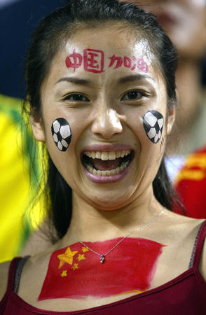 A supporter of China smiles before the begining of a Group C match against Brazil at the World Cup Finals in Sogwipo, June 8, 2002