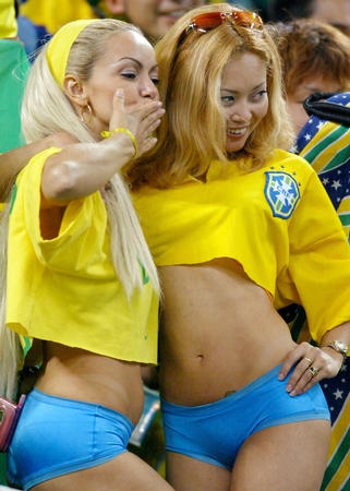 Two Brazil fans party in the stands before a World Cup semi-final match between Brazil and Turkey in Saitama June 26, 2002