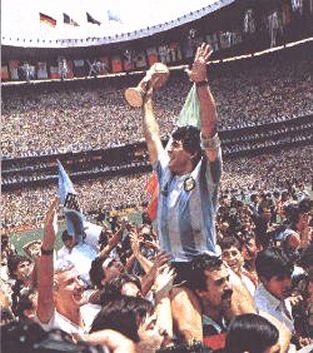 Maradona celebrates with the fans and the World Cup trophy. The Azteca Stadium still packed with 115.000 spectators even though the game was over a long time ago.