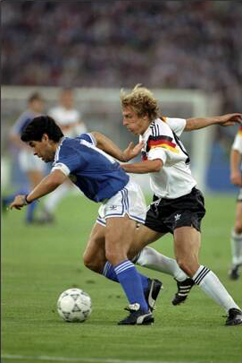 Diego Maradona with the ball chased by Jürgen Klinsmann.