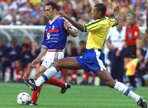 Youri Djorkaeff of France, left, is challenged by Junior Baiano of Brazil during the final of the soccer World Cup 98 between Brazil and France at the Stade de France in Saint Denis, north of Paris, Sunday, July 12, 1998.