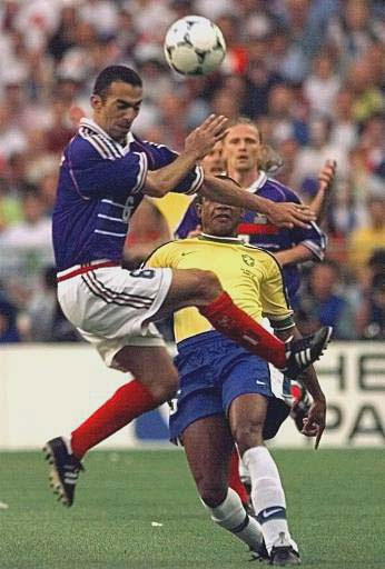 Youri Djorkaeff of France, left, attempts to charge down a clearance from Brazil's Cesar Sampaio during the final of the soccer World Cup 98 between Brazil and France at the Stade de France in Saint Denis, north of Paris, Sunday, July 12, 1998.